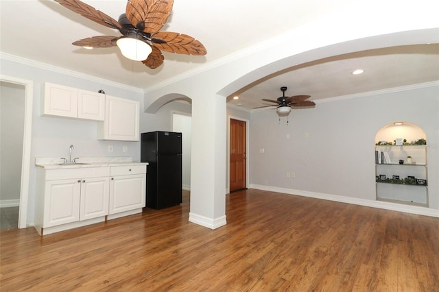 656 Lake Charm Dr, Oviedo, FL 32765 - kitchen with freestanding refrigerator, a sink, ceiling fan, arched walkways, and light countertops