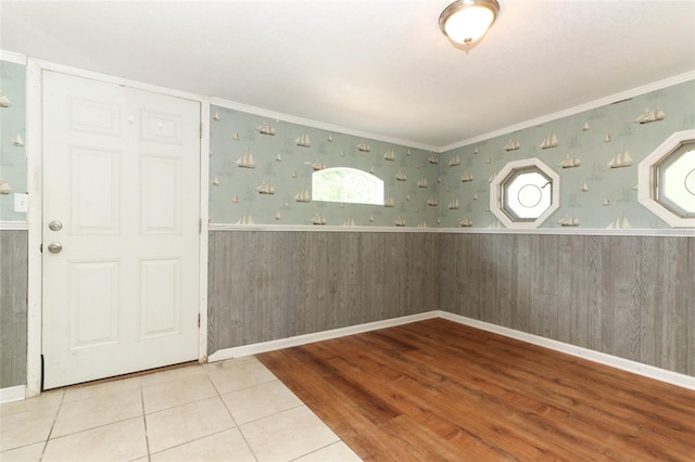 656 Lake Charm Dr, Oviedo, FL 32765 - empty room featuring a wainscoted wall, ornamental molding, wood finished floors, wooden walls, and wallpapered walls