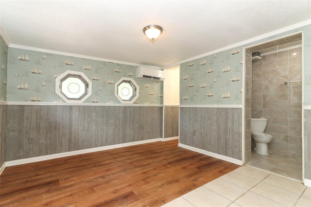 656 Lake Charm Dr, Oviedo, FL 32765 - spare room with a wall mounted air conditioner, crown molding, wainscoting, and wood finished floors