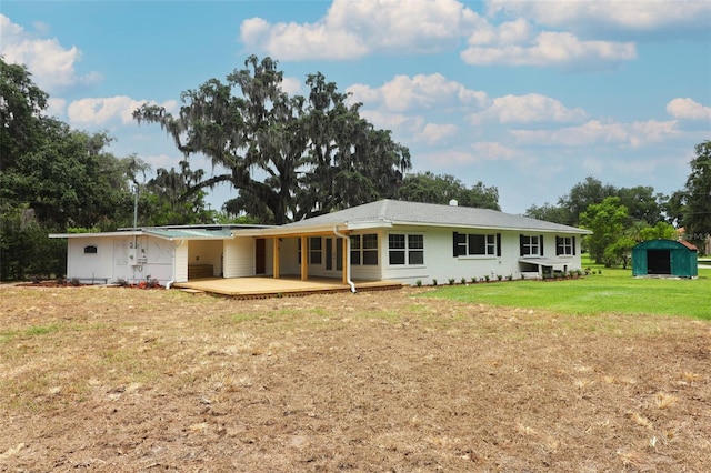 656 Lake Charm Dr, Oviedo, FL 32765 - rear view of property featuring a storage unit, an outdoor structure, a yard, and a carport