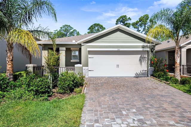 280 Caryota Ct, New Smyrna Beach, FL 32168 - ranch-style house with stucco siding, decorative driveway, an attached garage, and stone siding