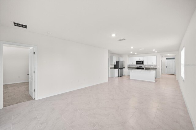 280 Caryota Ct, New Smyrna Beach, FL 32168 - unfurnished living room with recessed lighting and baseboards