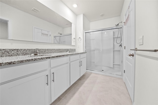 280 Caryota Ct, New Smyrna Beach, FL 32168 - bathroom with a stall shower, tile patterned floors, and double vanity