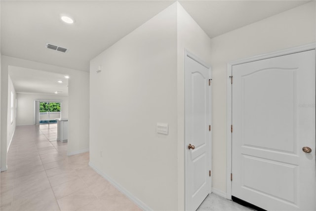 280 Caryota Ct, New Smyrna Beach, FL 32168 - corridor featuring light tile patterned flooring, baseboards, and recessed lighting