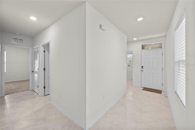 280 Caryota Ct, New Smyrna Beach, FL 32168 - corridor featuring recessed lighting, baseboards, and light tile patterned flooring