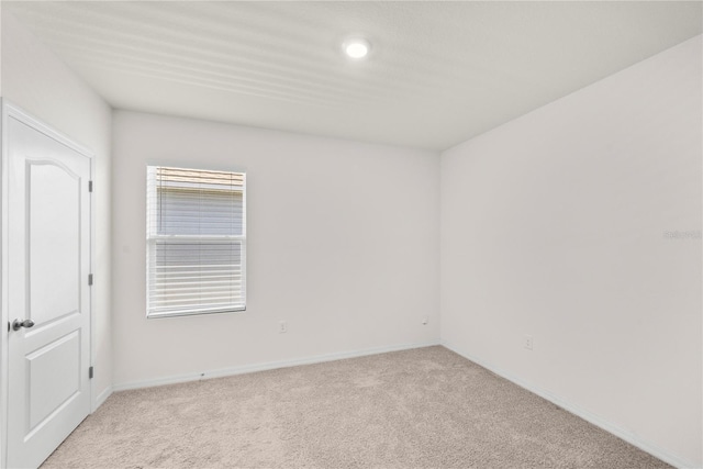 280 Caryota Ct, New Smyrna Beach, FL 32168 - unfurnished room with light carpet, baseboards, and recessed lighting