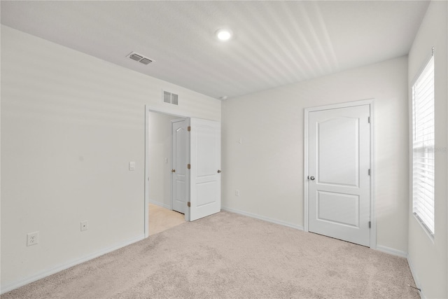 280 Caryota Ct, New Smyrna Beach, FL 32168 - unfurnished bedroom featuring carpet flooring, multiple windows, baseboards, and recessed lighting