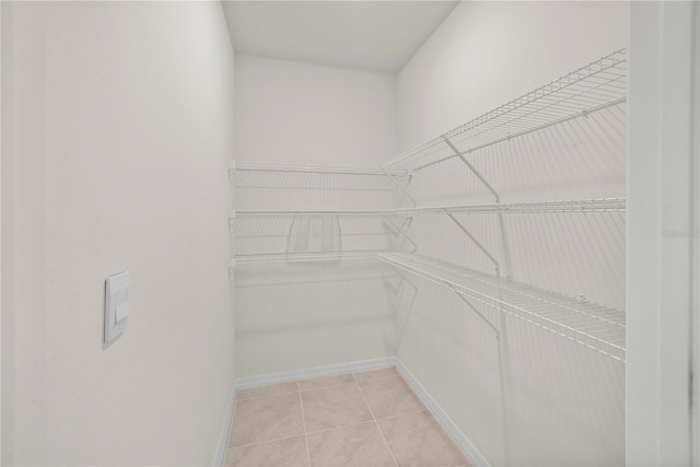 280 Caryota Ct, New Smyrna Beach, FL 32168 - spacious closet featuring light tile patterned flooring