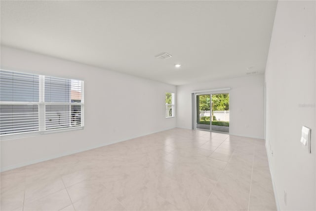 280 Caryota Ct, New Smyrna Beach, FL 32168 - empty room featuring light tile patterned floors and recessed lighting