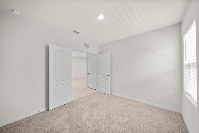280 Caryota Ct, New Smyrna Beach, FL 32168 - unfurnished bedroom featuring light colored carpet, baseboards, and recessed lighting