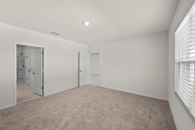 280 Caryota Ct, New Smyrna Beach, FL 32168 - unfurnished bedroom featuring light carpet, baseboards, and ensuite bathroom