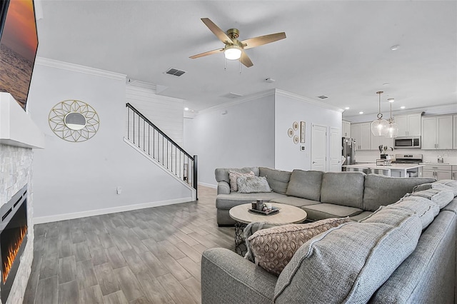 1123 Dora Parc Ln, Mount Dora, FL 32757 - living area with ceiling fan, crown molding, recessed lighting, stairs, and a lit fireplace
