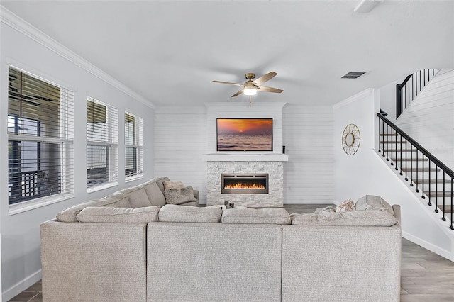 1123 Dora Parc Ln, Mount Dora, FL 32757 - living room featuring baseboards, ceiling fan, ornamental molding, a stone fireplace, and stairway