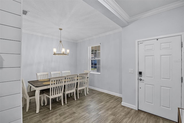 1123 Dora Parc Ln, Mount Dora, FL 32757 - dining space featuring wood finished floors, a chandelier, baseboards, ornamental molding, and a textured ceiling