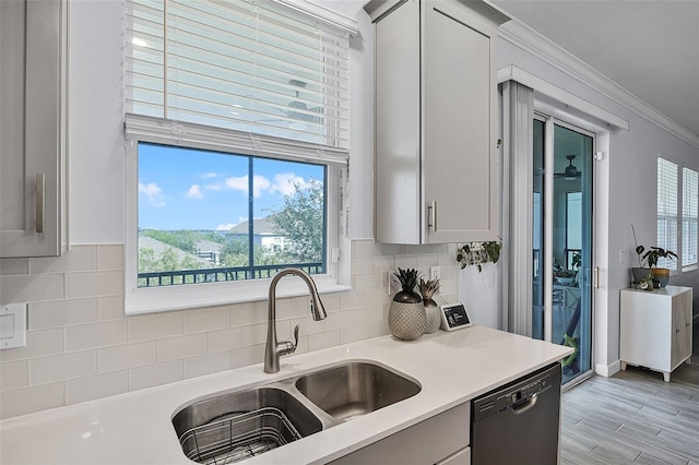 1123 Dora Parc Ln, Mount Dora, FL 32757 - kitchen with a sink, dishwashing machine, light countertops, backsplash, and ornamental molding