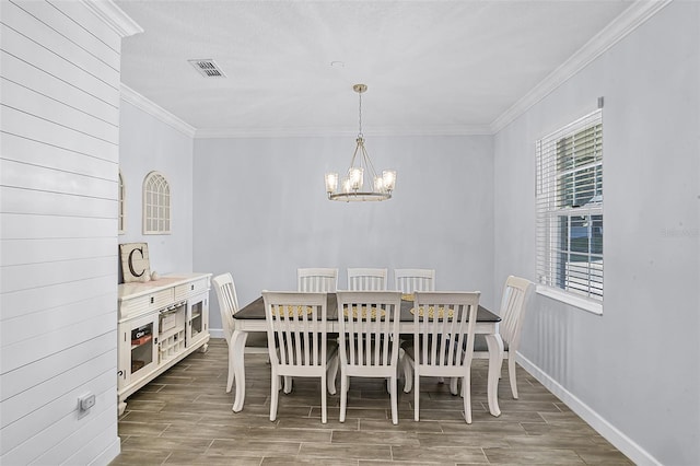 1123 Dora Parc Ln, Mount Dora, FL 32757 - dining space with wood finish floors, a chandelier, healthy amount of natural light, and ornamental molding