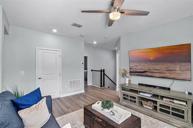 1123 Dora Parc Ln, Mount Dora, FL 32757 - living room with wood finished floors, ceiling fan, a textured ceiling, baseboards, and recessed lighting