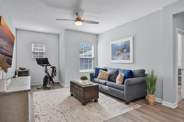 1123 Dora Parc Ln, Mount Dora, FL 32757 - living room with wood finished floors, a ceiling fan, baseboards, and a textured ceiling