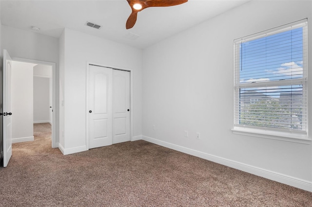 8692 Tavistock Lakes Blvd, Orlando, FL 32827 - unfurnished bedroom with carpet, a closet, and ceiling fan