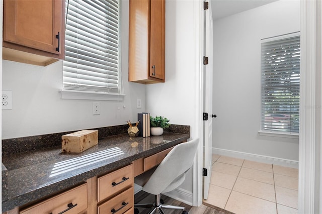 8692 Tavistock Lakes Blvd, Orlando, FL 32827 - home office featuring light tile patterned floors and built in desk