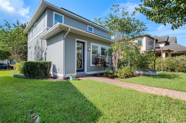 8692 Tavistock Lakes Blvd, Orlando, FL 32827 - view of side of property featuring stucco siding and a yard