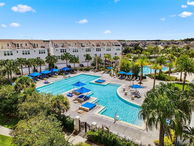 8692 Tavistock Lakes Blvd, Orlando, FL 32827 - community pool with a residential view and a patio area