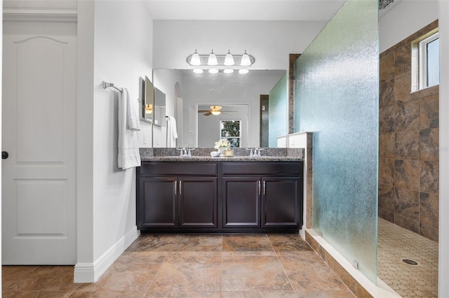 8692 Tavistock Lakes Blvd, Orlando, FL 32827 - bathroom featuring double vanity, a walk in shower, and a ceiling fan