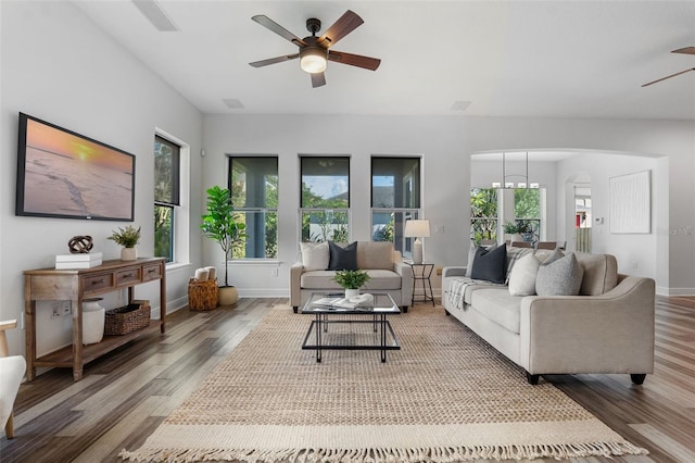 8692 Tavistock Lakes Blvd, Orlando, FL 32827 - living room featuring ceiling fan, arched walkways, and wood finished floors
