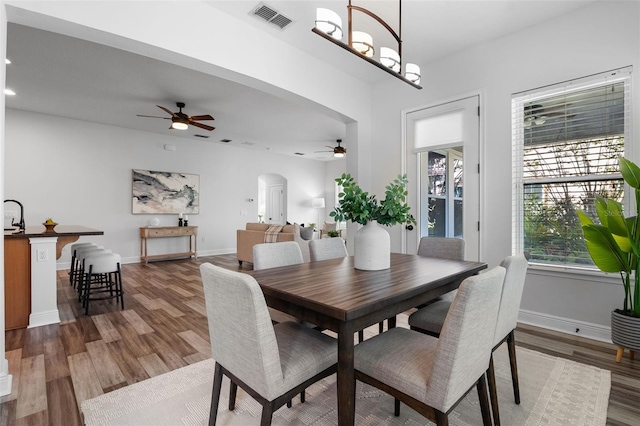 8692 Tavistock Lakes Blvd, Orlando, FL 32827 - dining area with a ceiling fan, arched walkways, wood finished floors, and recessed lighting