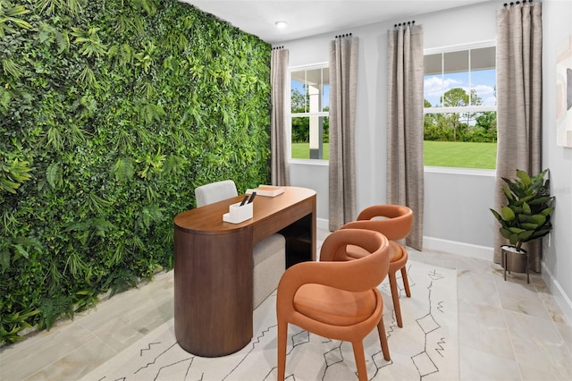 living area with baseboards and plenty of natural light