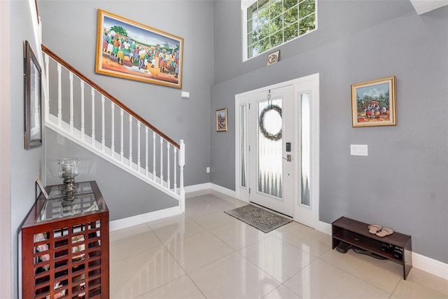 3063 Mandolin Dr, Kissimmee, FL 34744 - entryway featuring stairs, baseboards, tile patterned floors, and a towering ceiling