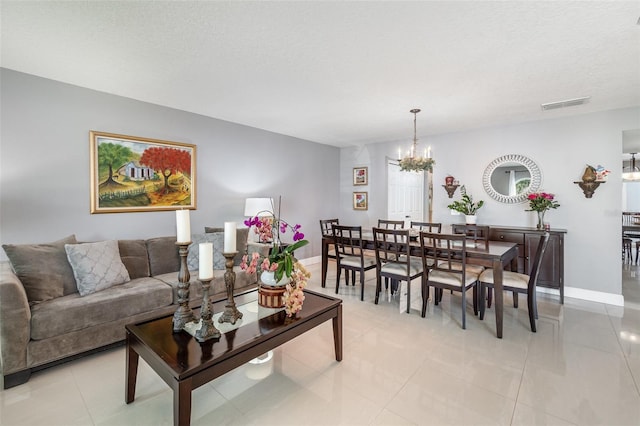 3063 Mandolin Dr, Kissimmee, FL 34744 - living area featuring a chandelier, light tile patterned floors, baseboards, and a textured ceiling