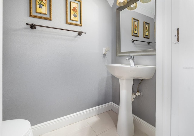 3063 Mandolin Dr, Kissimmee, FL 34744 - bathroom with toilet, baseboards, and tile patterned flooring