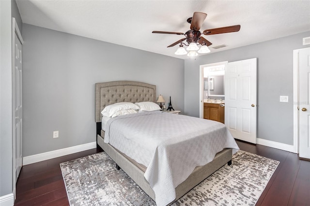 3063 Mandolin Dr, Kissimmee, FL 34744 - bedroom with baseboards, dark wood-style floors, ceiling fan, and connected bathroom