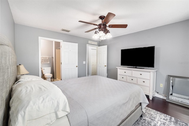 3063 Mandolin Dr, Kissimmee, FL 34744 - bedroom with dark wood-type flooring, baseboards, a ceiling fan, and ensuite bathroom