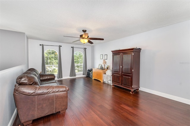 3063 Mandolin Dr, Kissimmee, FL 34744 - living area with dark wood-style flooring, ceiling fan, baseboards, and a textured ceiling