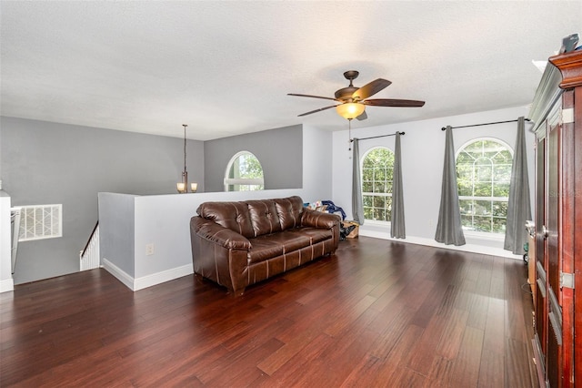 3063 Mandolin Dr, Kissimmee, FL 34744 - living area featuring dark wood-type flooring, a ceiling fan, baseboards, and a textured ceiling