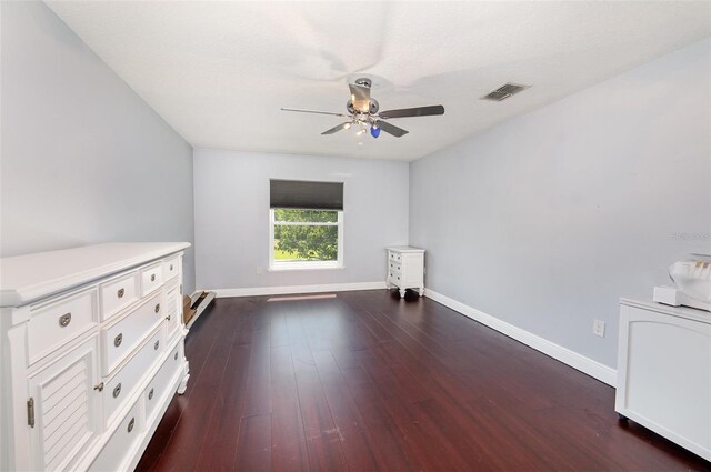 3063 Mandolin Dr, Kissimmee, FL 34744 - unfurnished bedroom featuring baseboards, dark wood finished floors, ceiling fan, and a baseboard heating unit