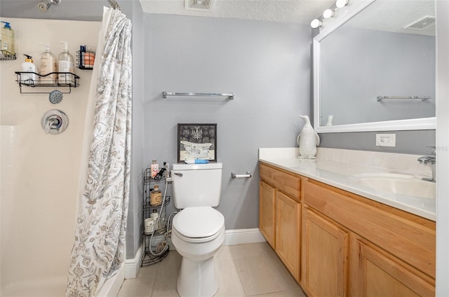 3063 Mandolin Dr, Kissimmee, FL 34744 - bathroom featuring toilet, vanity, a tile shower, tile patterned flooring, and baseboards