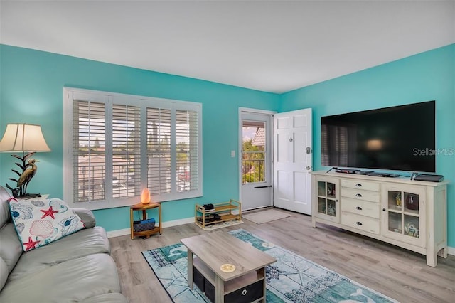 living area with wood finished floors and baseboards
