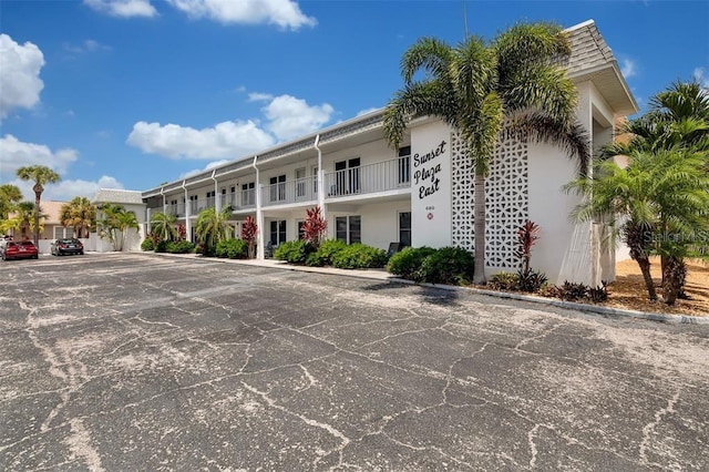 view of building exterior with uncovered parking
