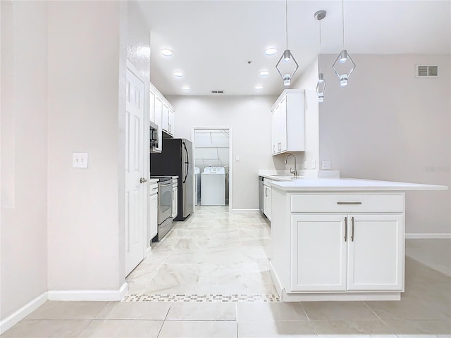 3000 Laurel Park Ln Unit 202, Kissimmee, FL 34741 - kitchen featuring appliances with stainless steel finishes, washer and dryer, baseboards, and recessed lighting