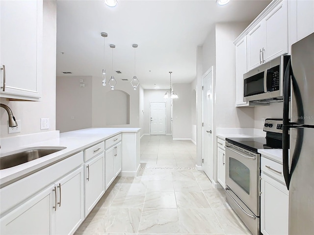 3000 Laurel Park Ln Unit 202, Kissimmee, FL 34741 - kitchen featuring stainless steel appliances, white cabinets, a sink, light countertops, and recessed lighting