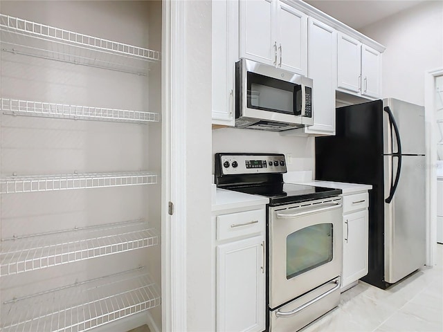 3000 Laurel Park Ln Unit 202, Kissimmee, FL 34741 - kitchen with appliances with stainless steel finishes, white cabinetry, and light countertops