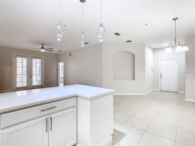 3000 Laurel Park Ln Unit 202, Kissimmee, FL 34741 - kitchen with open floor plan, light countertops, decorative light fixtures, white cabinetry, and ceiling fan