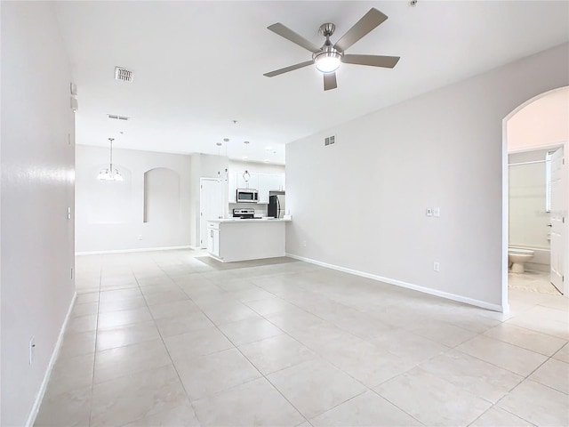 3000 Laurel Park Ln Unit 202, Kissimmee, FL 34741 - unfurnished living room with arched walkways, ceiling fan, light tile patterned floors, a chandelier, and baseboards