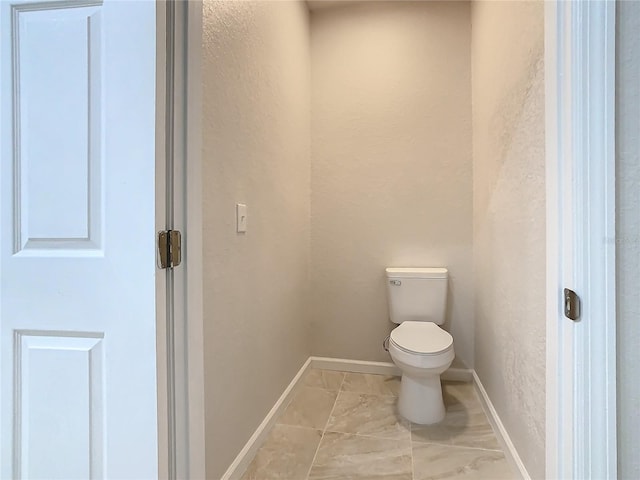3000 Laurel Park Ln Unit 202, Kissimmee, FL 34741 - bathroom featuring toilet, a textured wall, and baseboards