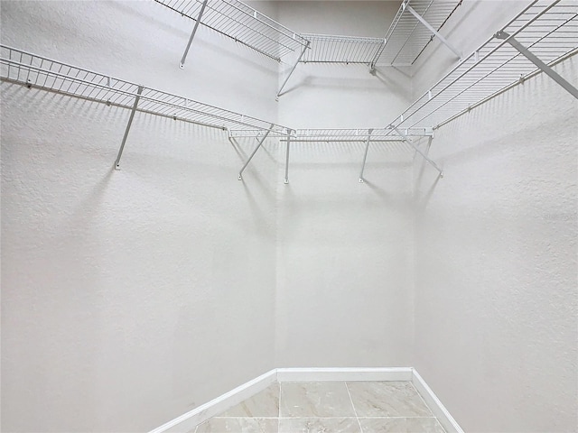 3000 Laurel Park Ln Unit 202, Kissimmee, FL 34741 - walk in closet featuring marble finish floors