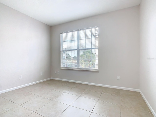 3000 Laurel Park Ln Unit 202, Kissimmee, FL 34741 - spare room with light tile patterned floors and baseboards