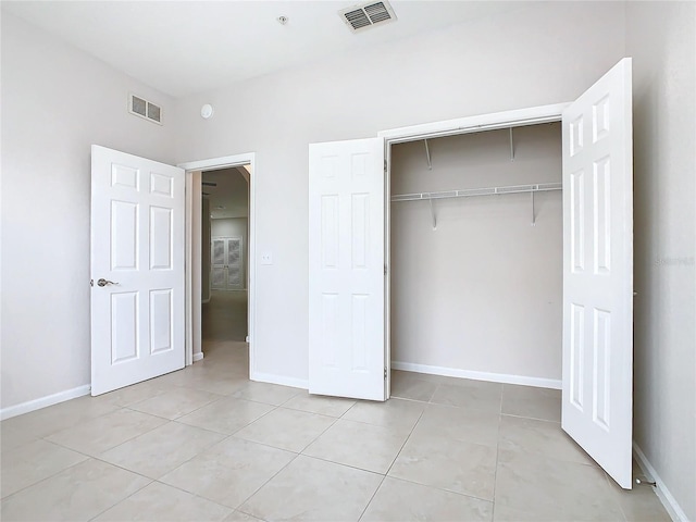 3000 Laurel Park Ln Unit 202, Kissimmee, FL 34741 - unfurnished bedroom featuring light tile patterned floors, a closet, and baseboards
